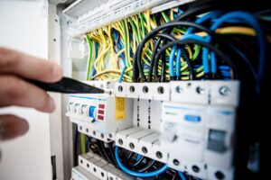 Electrician inspecting an electrical consumer unit