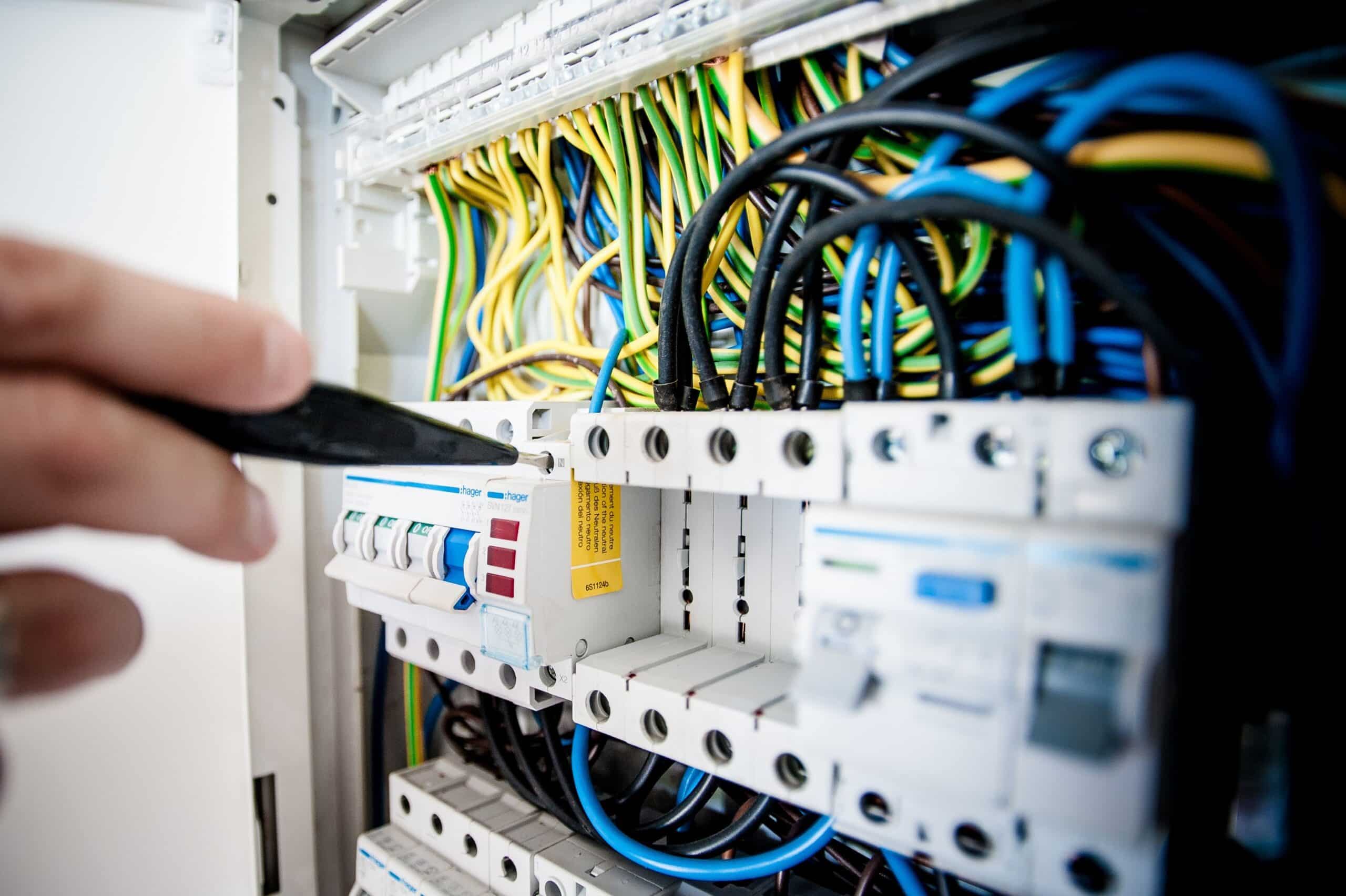 Electrician inspecting an electrical consumer unit